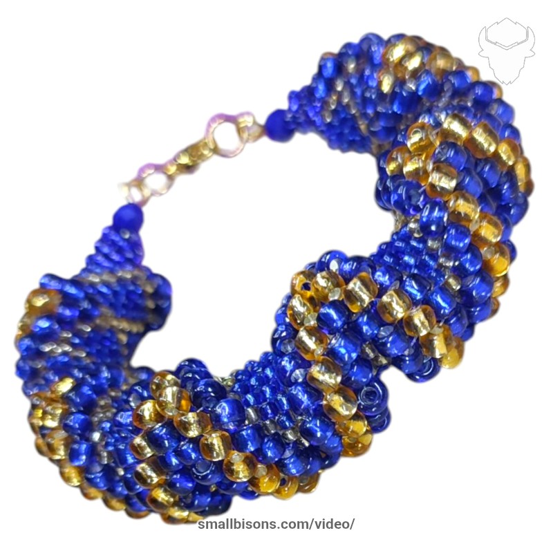 Pulsera AVA en azul y dorado elaborado en cuentas Nro. 2mm y 4mm en zig zag